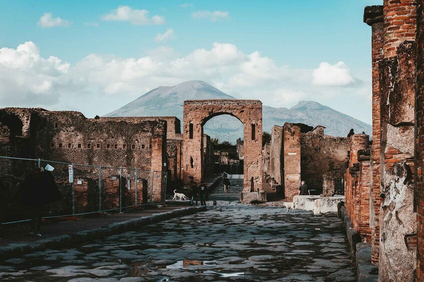 An ancient stone archway leading to a mountain in the background. 3