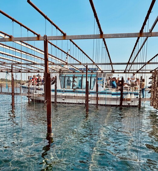 A boat docked at a pier with a metal structure overhead. 5