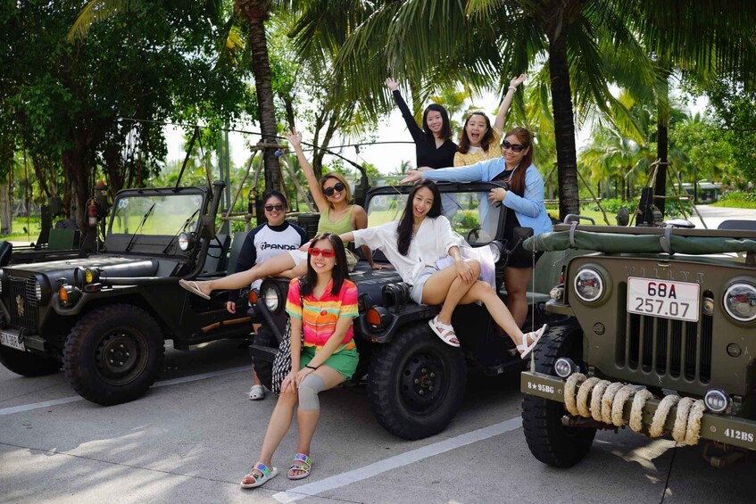 A group of people on a jeep with a license plate '68A 257.07' and a rope detail on the front. 3