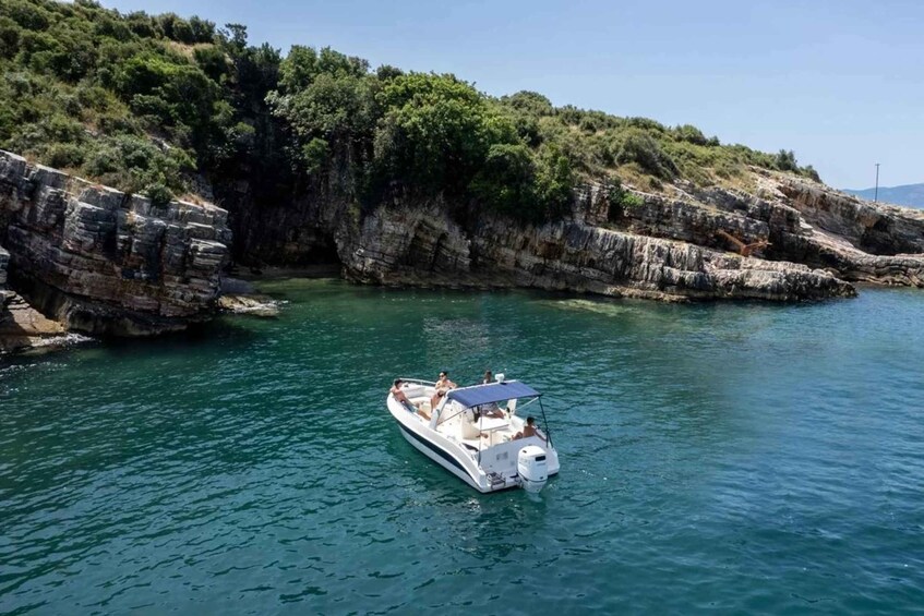 A boat on calm waters near rocky cliffs. 4