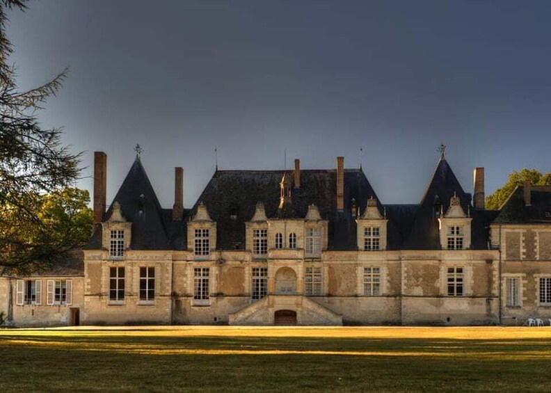 A large, historic building with multiple chimneys and a symmetrical facade. 5