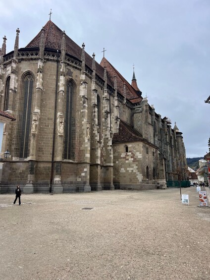 A historic church with a large central nave, tall arched windows, and a tiled roof. 4