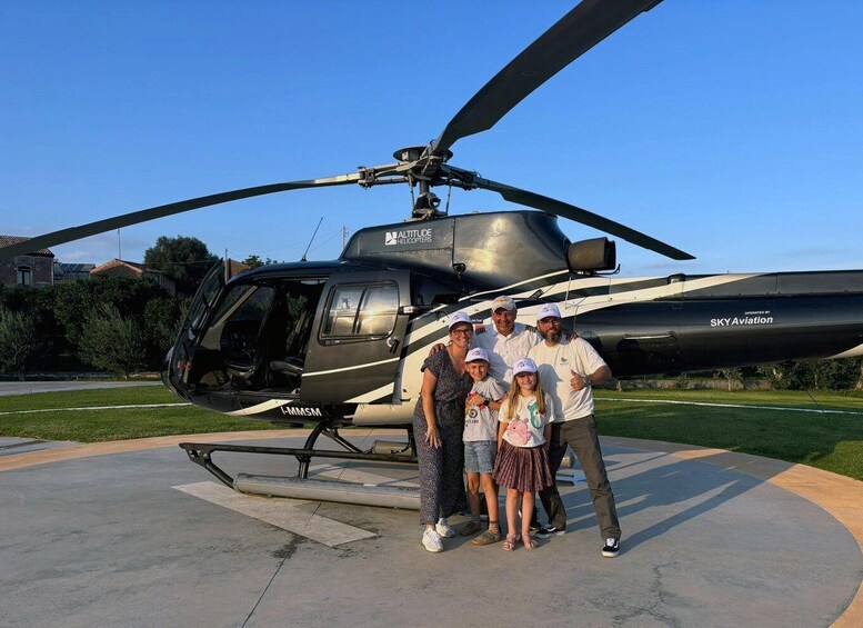 A family posing in front of a helicopter with the text "SKY Aviation" on its side. 4