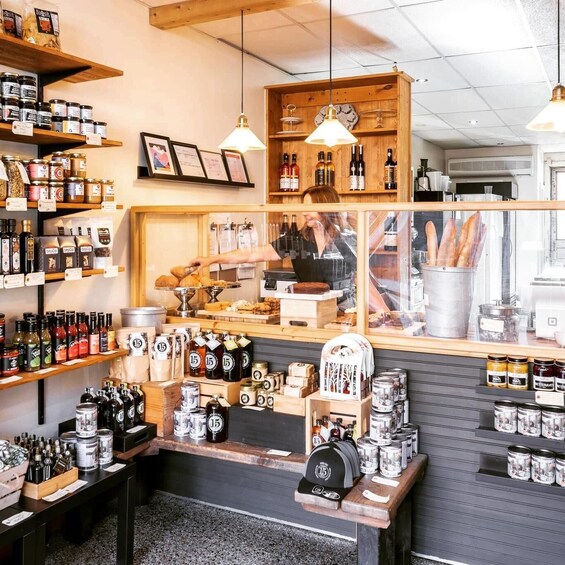 A store with shelves of jars and bottles, wooden display cases, and hanging lights. 3