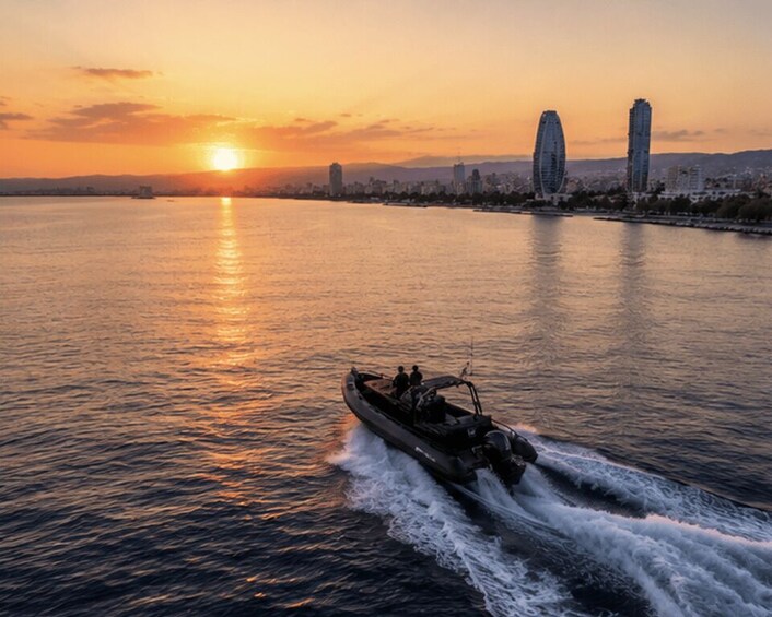 A sunset over a body of water with a boat and two buildings in the background. 1