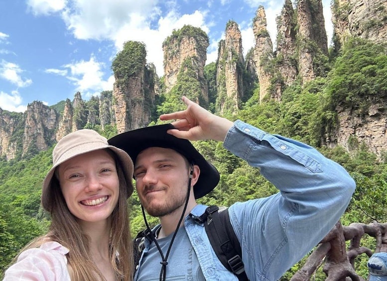 A couple taking a selfie with a mountainous landscape in the background. 4