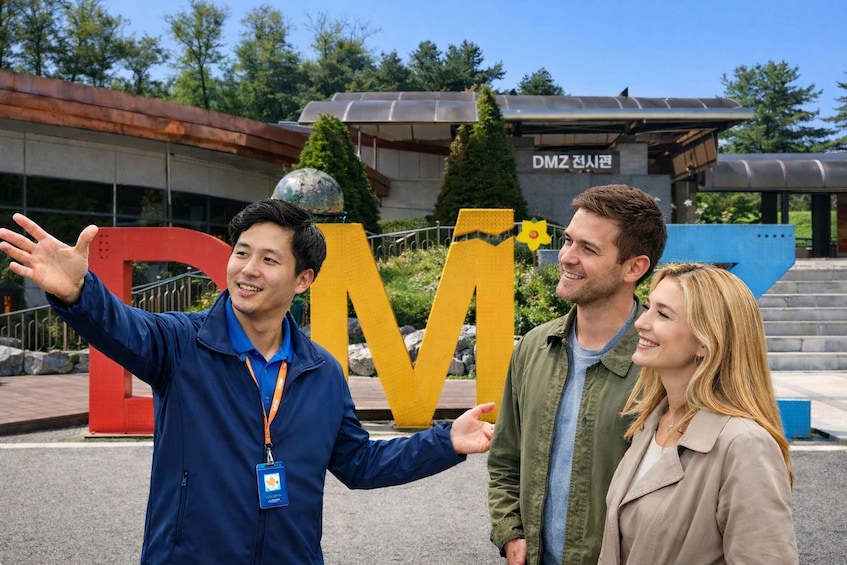 A group of people in front of a large yellow 'M' sign with a building in the background. 1