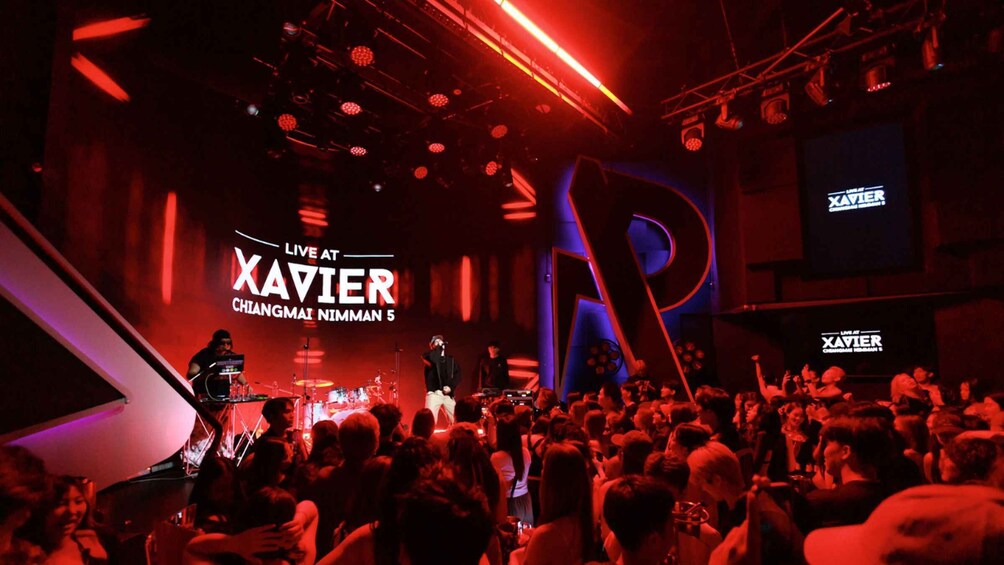 A live music event at Xavier with a crowd in a dimly lit venue. 2