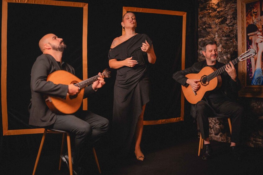 Three people performing music on stage with guitars. 5
