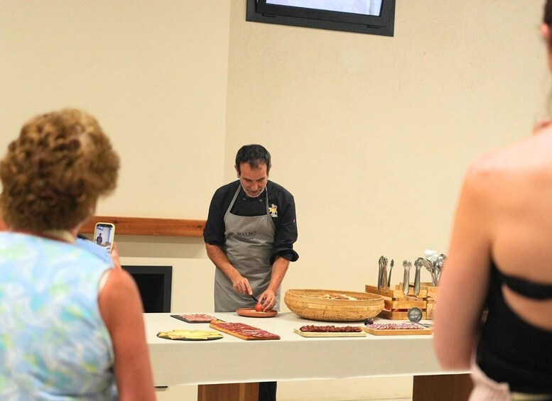 A chef preparing food at a counter with various ingredients and utensils. 4
