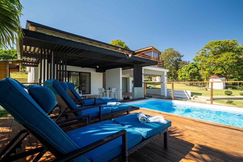 A poolside area with lounge chairs and a wooden deck. 2