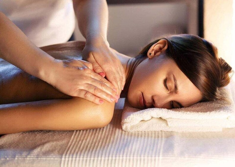 A person receiving a massage on a massage table. 1