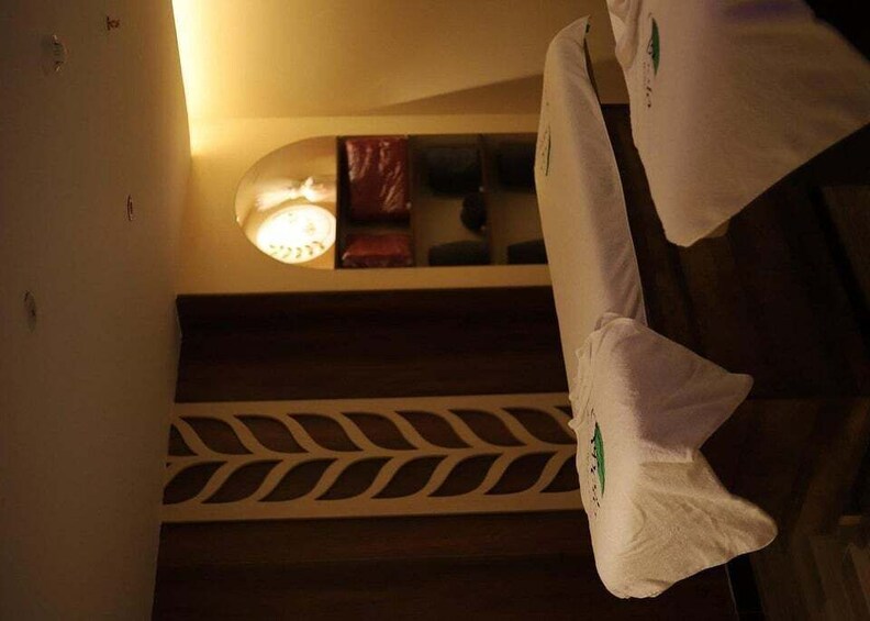 A staircase with a patterned railing and a light fixture above. 5