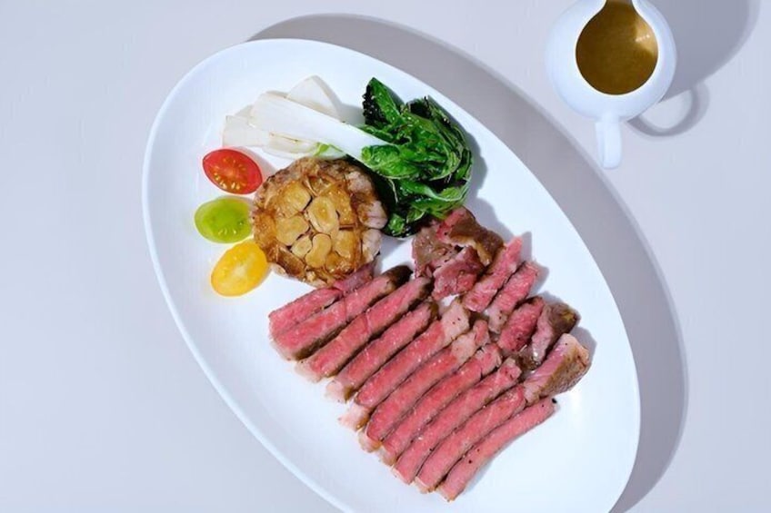 A plate with sliced steak, a baked potato, and vegetables. 4