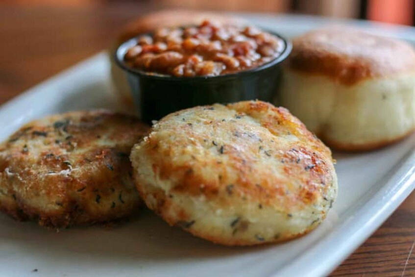 Three cheese scones on a plate with a side of baked beans. 1
