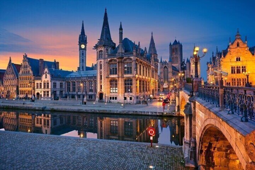 A historic European cityscape with a river, bridges, and illuminated buildings at dusk. 5