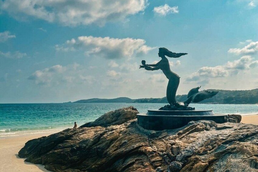 A statue on a rock by the sea. 1