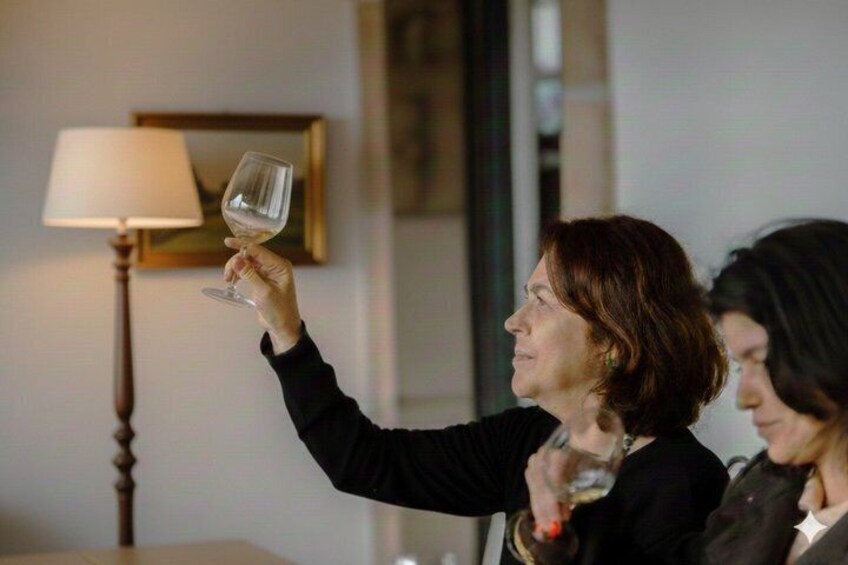 A person holding a wine glass. 2