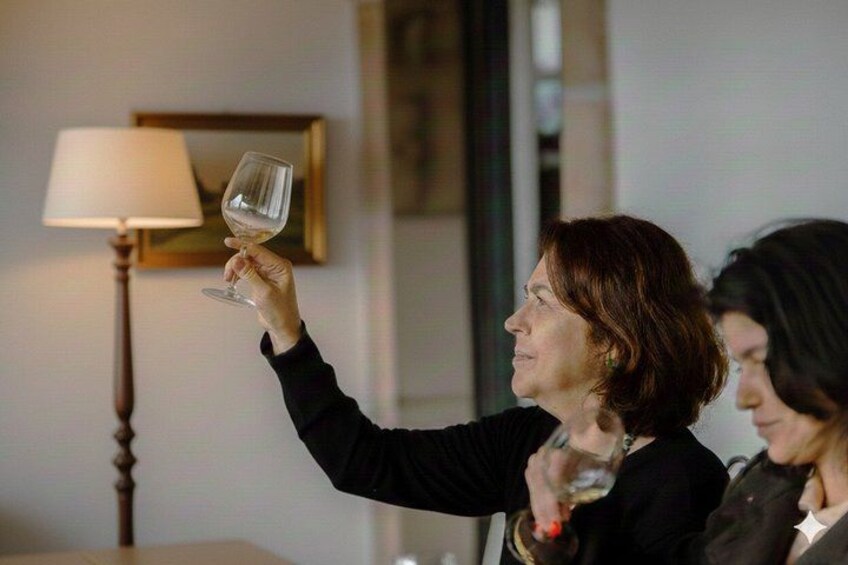 A person holding a wine glass. 2