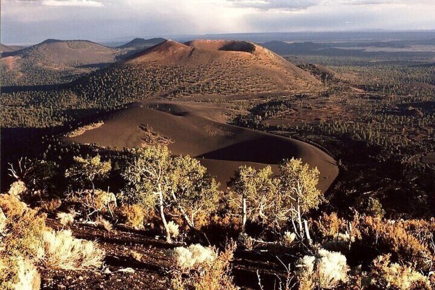 A mountainous landscape with a valley and forested hills. 4
