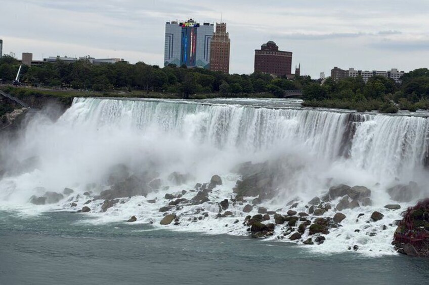 A waterfall with a cityscape in the background. 5