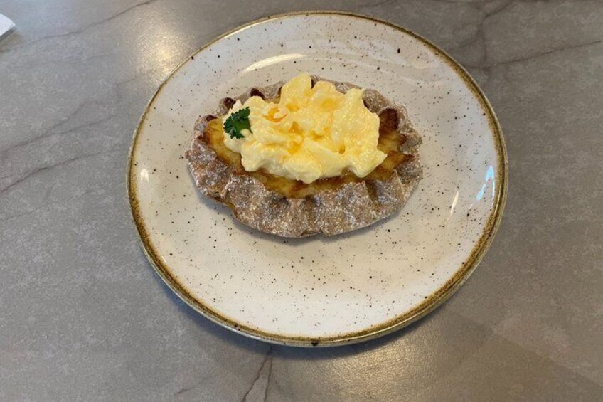 A plate with a dessert on a speckled ceramic plate. 4