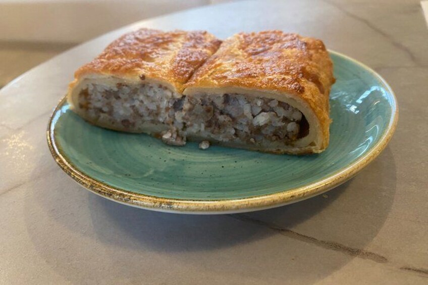 A slice of a stuffed pastry on a teal plate. 2