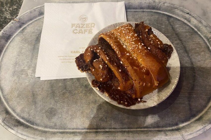 A plate with a dessert, a menu, and a metal tray. 3