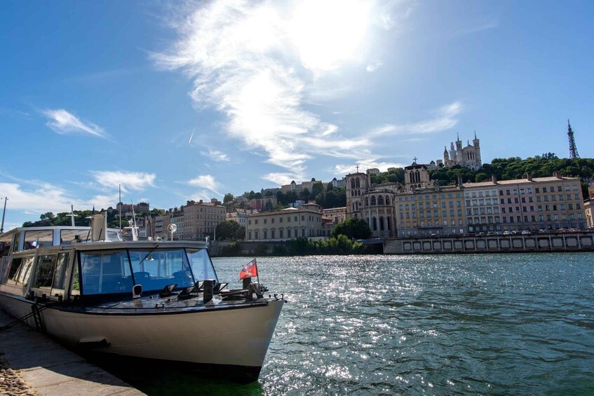 A boat docked at a harbor with a historic building in the background. 5