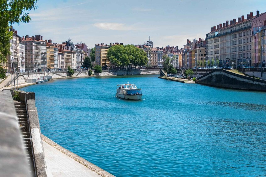 A river with a boat, surrounded by historic buildings and a bridge. 2