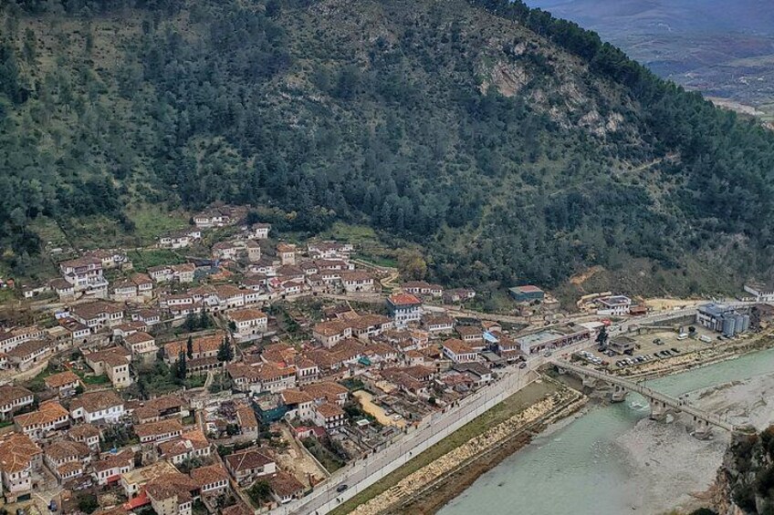 A coastal town with terraced houses, a river, and a bridge. 3
