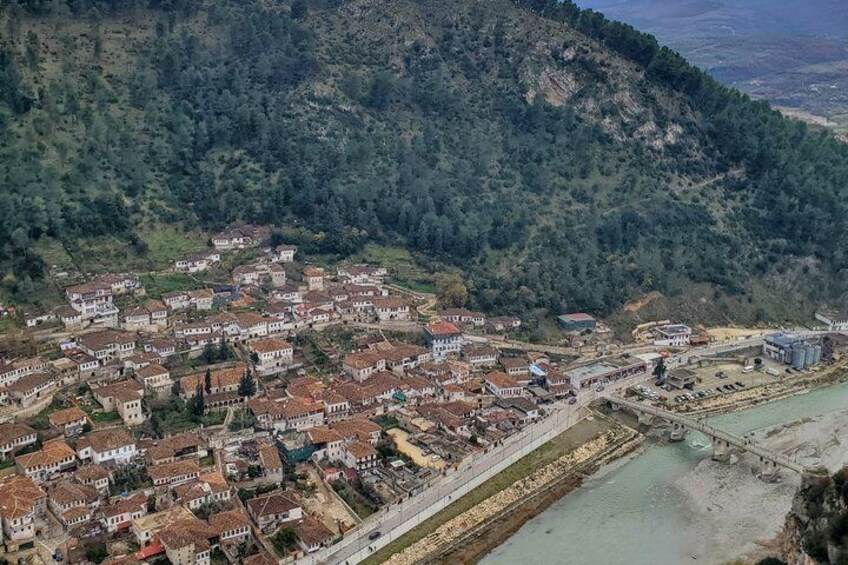 A town nestled in a valley with a river, surrounded by hills. 3