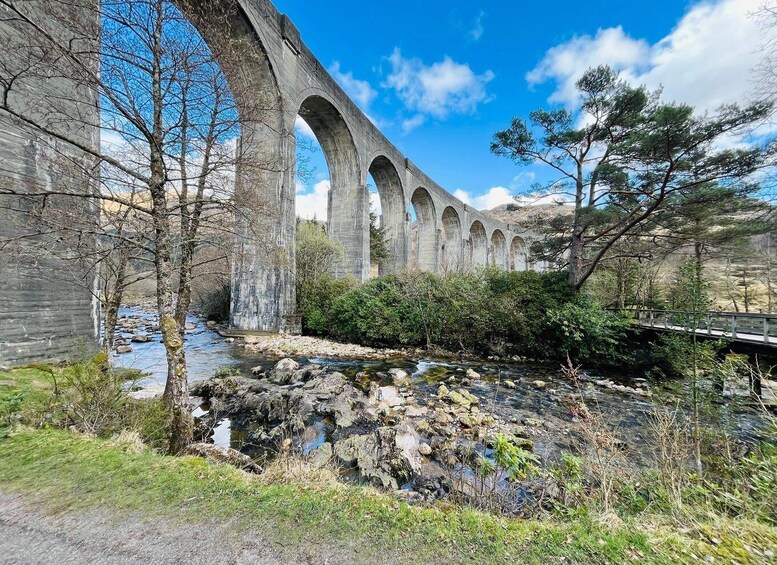 A stone viaduct over a river with a bridge crossing. 1
