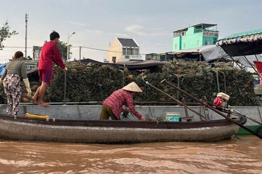 People on a boat in a body of water, with buildings in the background. 2