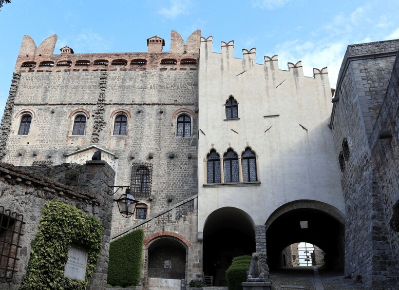 A historic stone building with arched windows and a tower. 2