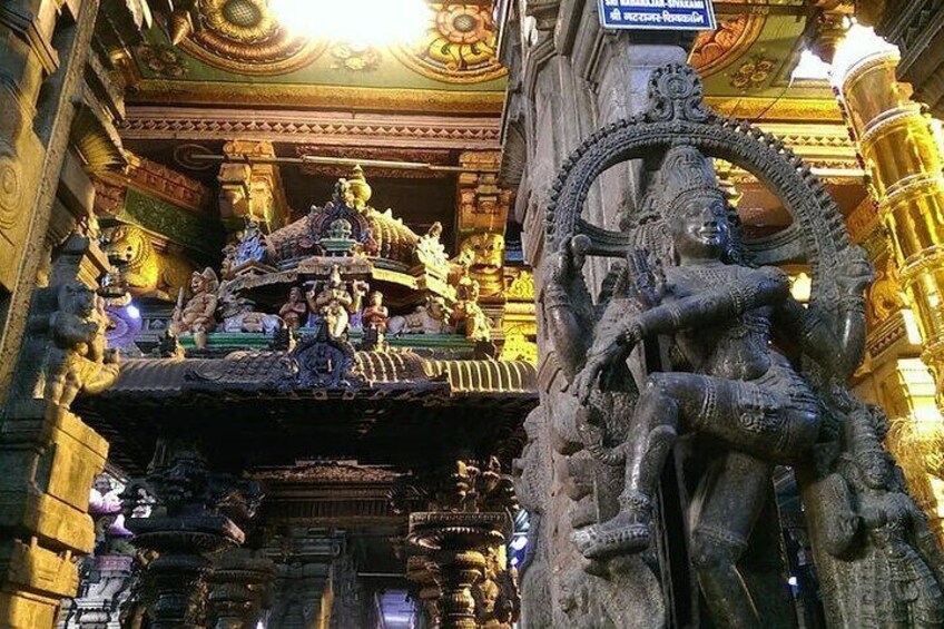 A temple with intricate carvings and statues, including a prominent figure seated on a lotus. 1