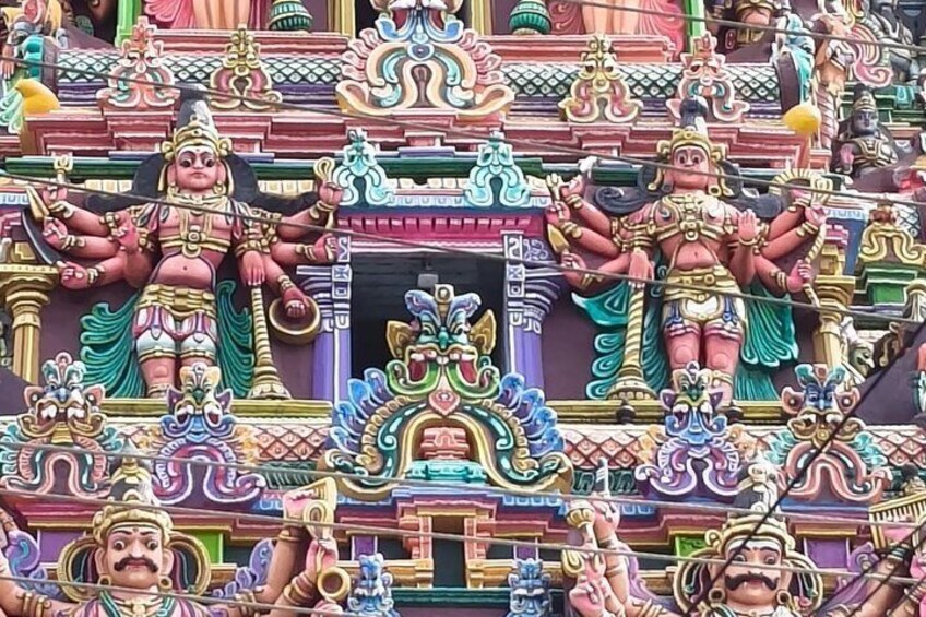 A colorful temple facade with intricate carvings and statues. 2