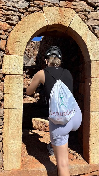 A person climbing a stone staircase. 4