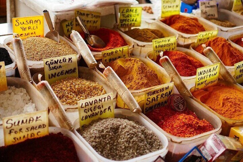 A variety of spices in containers with labels, including turmeric, cumin, and coriander. 3
