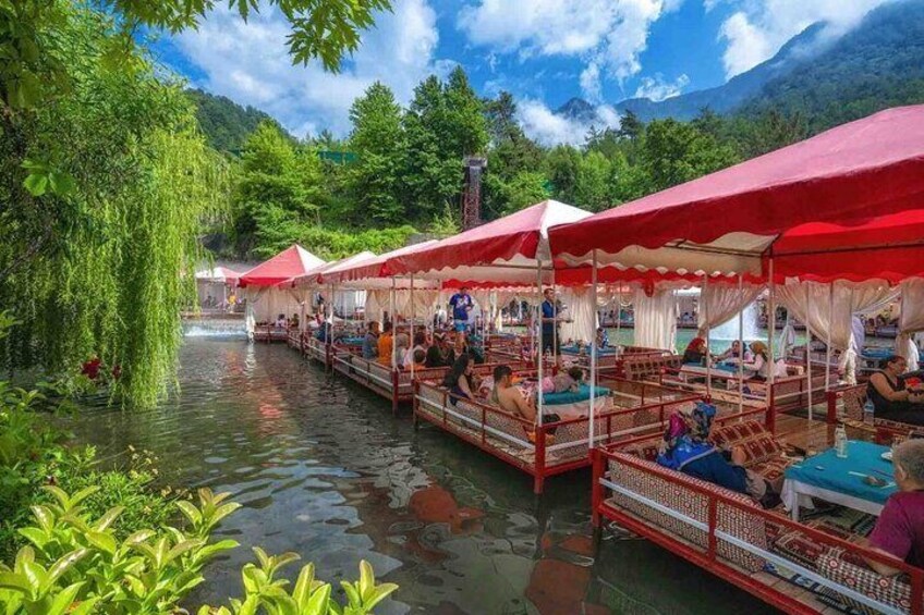 A river with floating canopies and people relaxing. 3