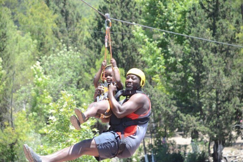A person zip-lining through a forested area. 4
