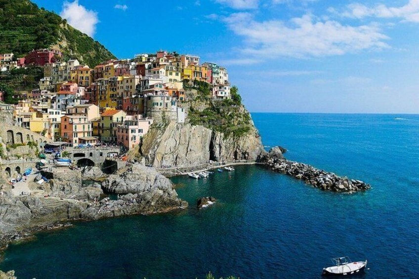 A coastal village with colorful buildings perched on a cliff overlooking the sea. 3