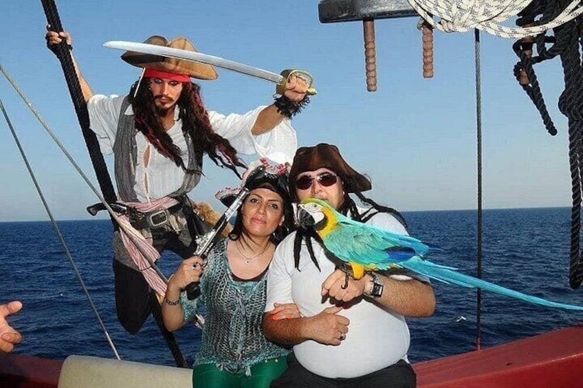 A group of people on a boat with a parrot. 5