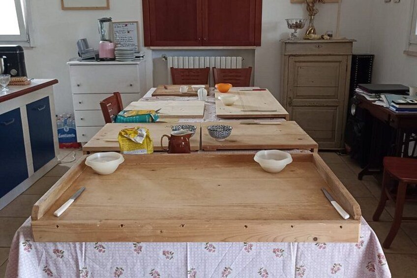 A kitchen with a wooden table, chairs, and various kitchen items. 4