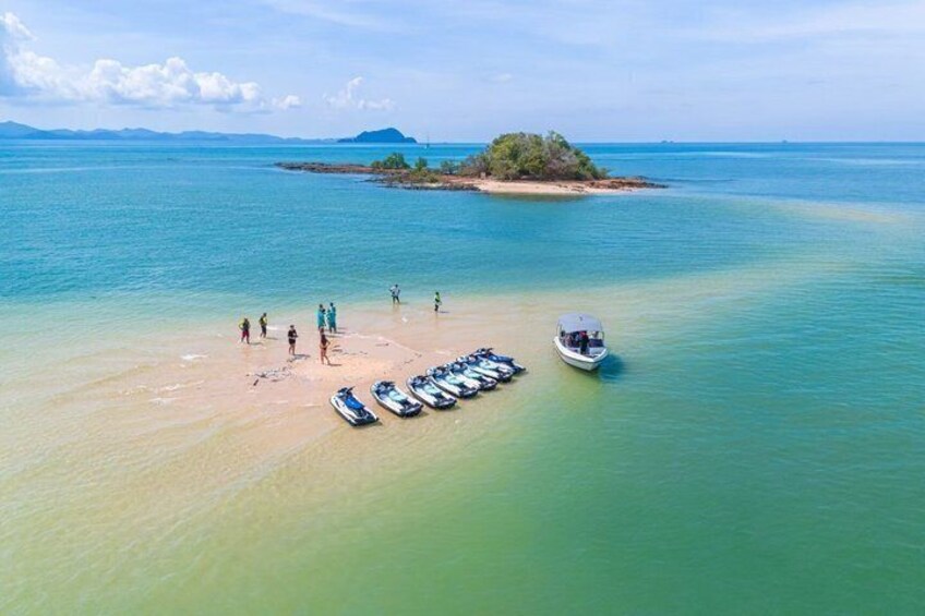 A beach with boats and people. 4