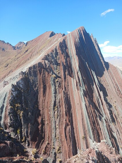 A mountain with distinct layered rock formations. 4