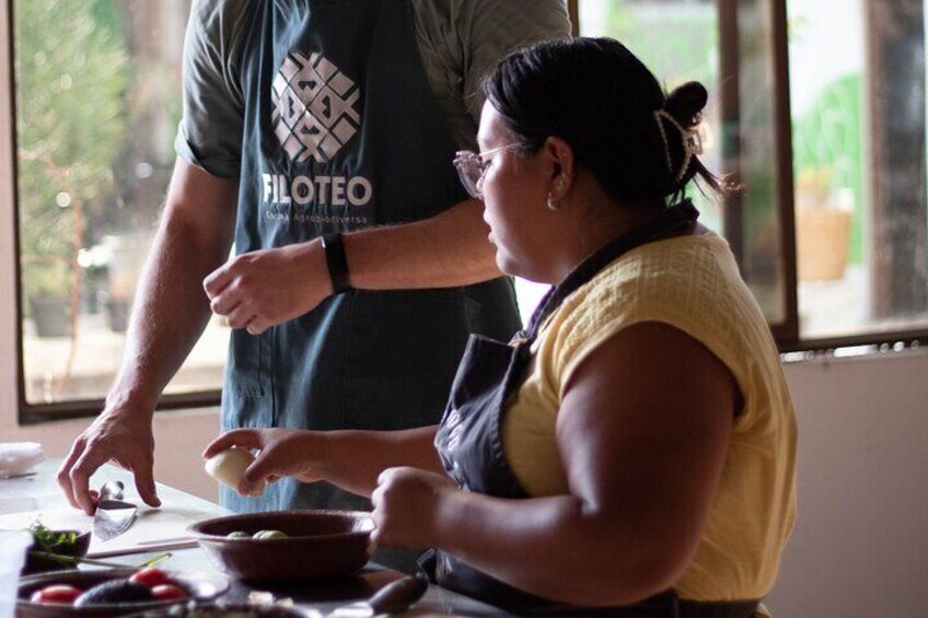 A person cooking with a bowl and vegetables on a table. 3