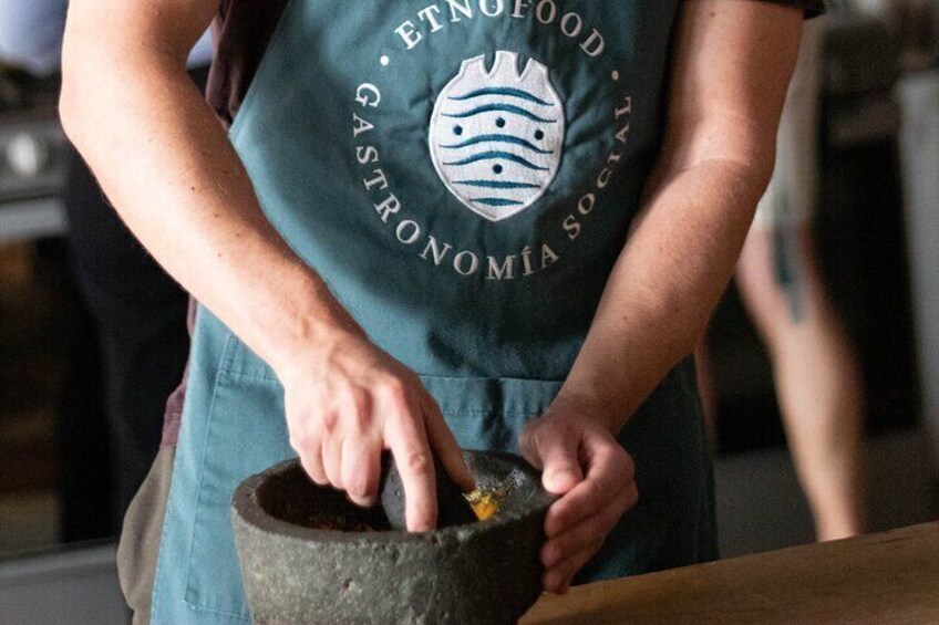 A person grinding spices in a mortar. 4