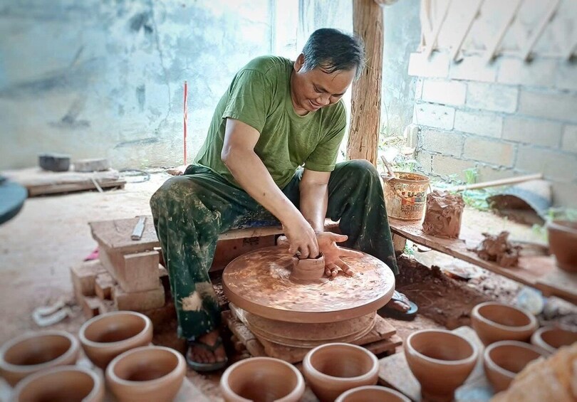 A person shaping clay on a pottery wheel. 3