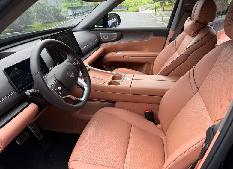 A car interior with a steering wheel, dashboard, and beige leather seats. 2